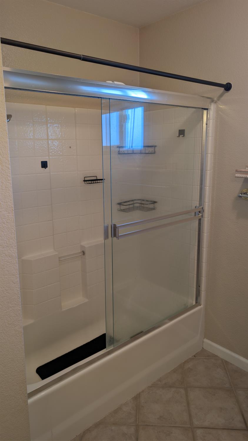 3248 Sudbury Road Cameron Park, CA 95682 - Photo 29 of 41 a bathroom with a glass shower door