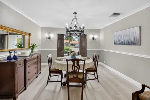a large kitchen with a lot of counter space and a wooden floor