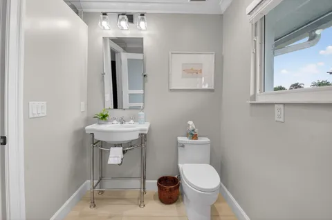 a bathroom with a sink a toilet and shower curtain