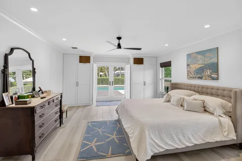 a view of a patio with a table chairs and a floor to ceiling window