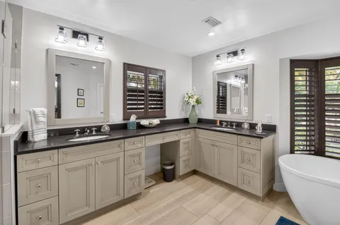 an aerial view of a house with swimming pool patio and lake view