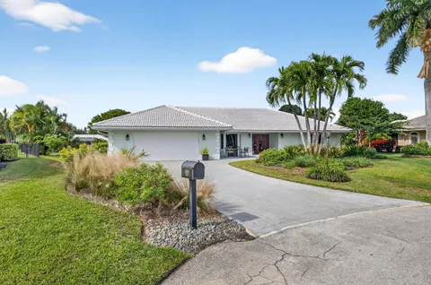 a front view of a house with a garden and patio