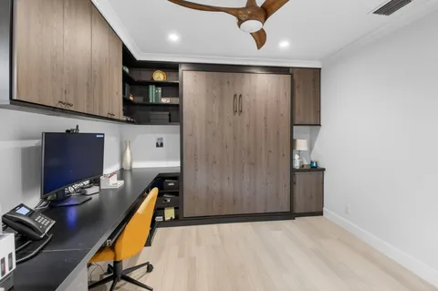 an aerial view of residential houses with outdoor space and trees