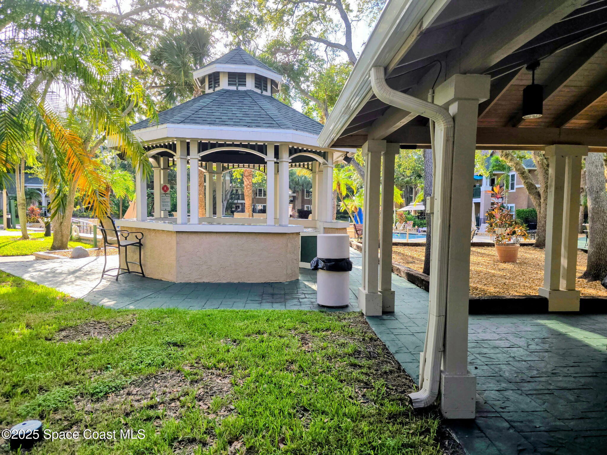7667 North Wickham Road, Unit 416 Melbourne, FL 32940 - Photo 20 of 30 a view of a house with a porch and furniture