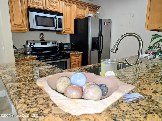 a kitchen with a refrigerator a stove and a sink
