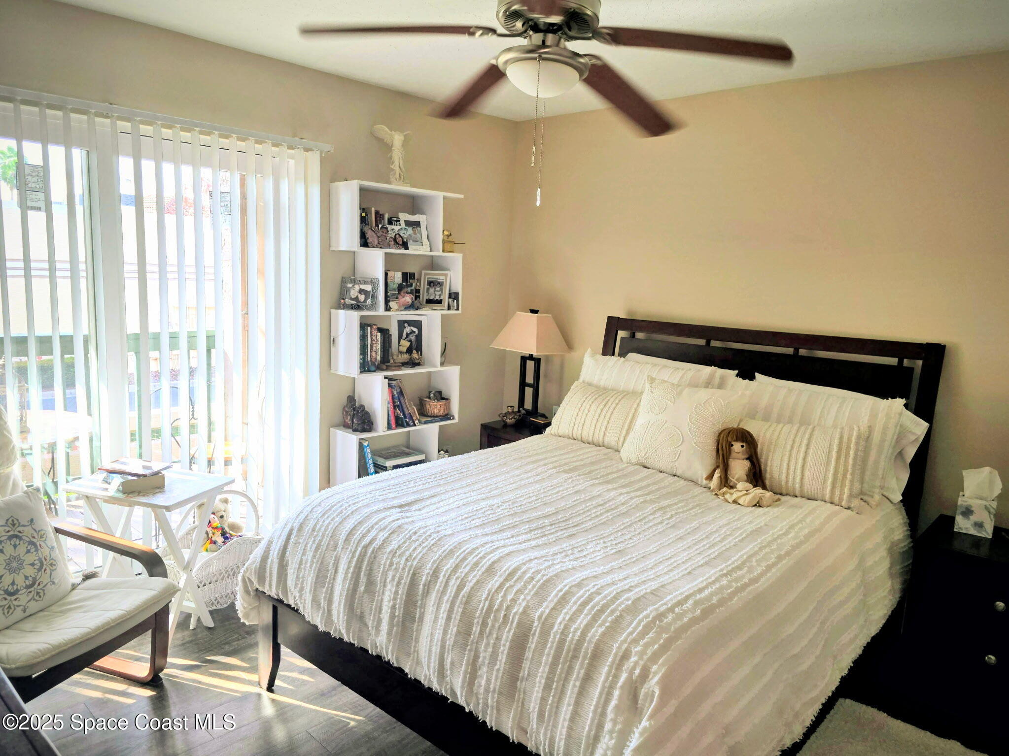 7667 North Wickham Road, Unit 416 Melbourne, FL 32940 - Photo 9 of 30 a bedroom with a bed and wooden floor
