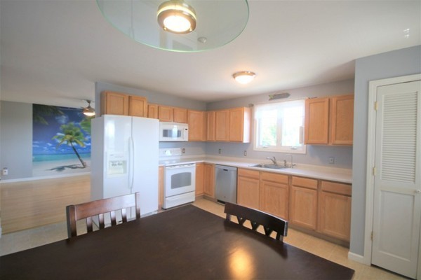 25 George Street, Unit 5 Dudley, MA 01571 - Photo 11 of 42 a kitchen with a refrigerator and a sink