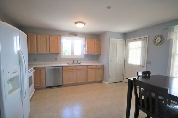 25 George Street, Unit 5 Dudley, MA 01571 - Photo 12 of 42 a kitchen with a window a sink and a refrigerator