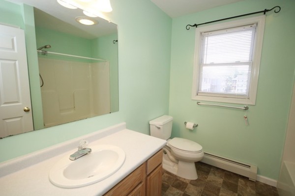 25 George Street, Unit 5 Dudley, MA 01571 - Photo 26 of 42 a bathroom with a sink toilet and a mirror