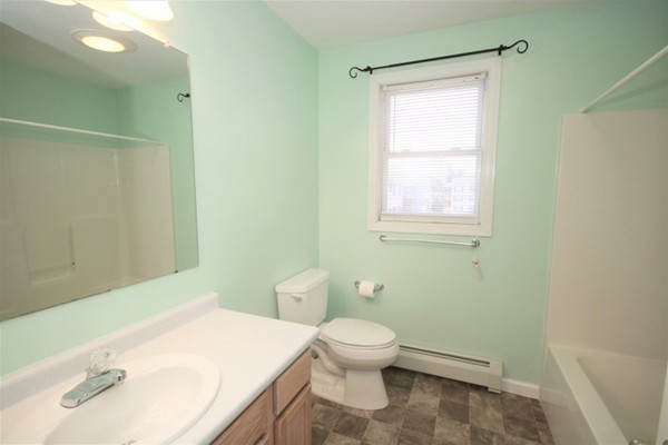 25 George Street, Unit 5 Dudley, MA 01571 - Photo 27 of 42 a bathroom with a sink a toilet and a mirror