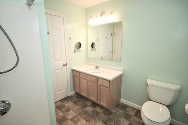 25 George Street, Unit 5 Dudley, MA 01571 - Photo 29 of 42 a bathroom with a sink a toilet and shower