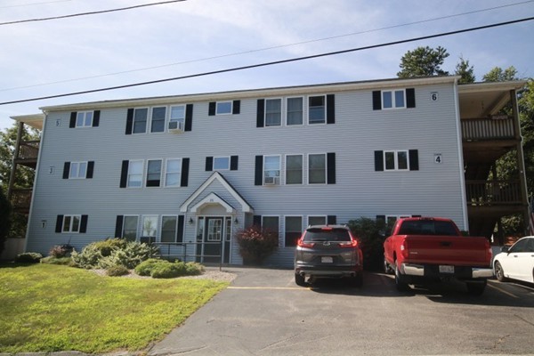 25 George Street, Unit 5 Dudley, MA 01571 - Photo 3 of 42 a front view of a house with a yard