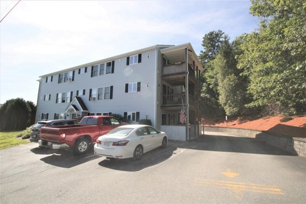 25 George Street, Unit 5 Dudley, MA 01571 - Photo 35 of 42 a front view of a house with parking space
