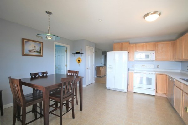 25 George Street, Unit 5 Dudley, MA 01571 - Photo 4 of 42 a view of a kitchen with a table and chairs