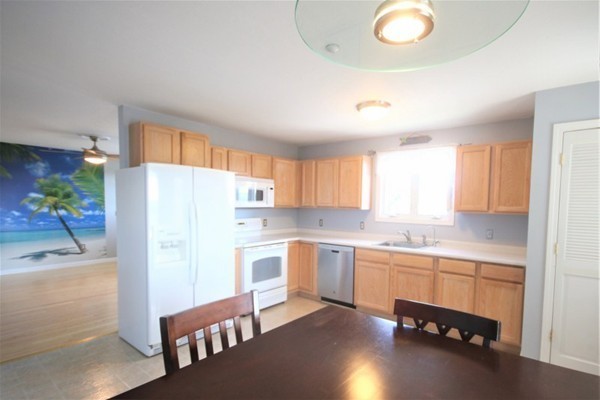 25 George Street, Unit 5 Dudley, MA 01571 - Photo 5 of 42 a kitchen with a sink a refrigerator and a stove