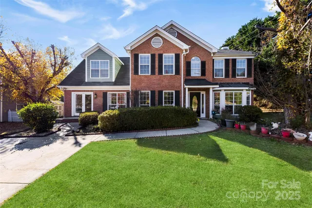 a front view of a house with a yard table and chairs
