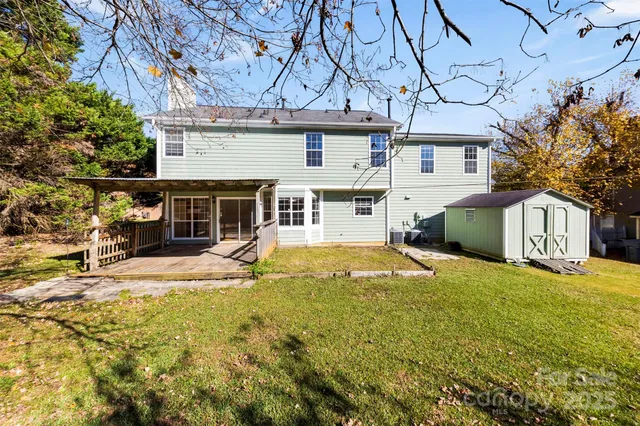 a view of house with yard and sitting area