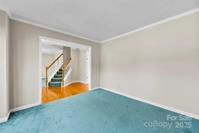 a view of an empty room with stairs