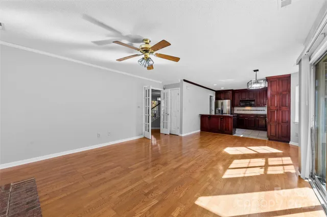 a view of a livingroom with a kitchen and a stove