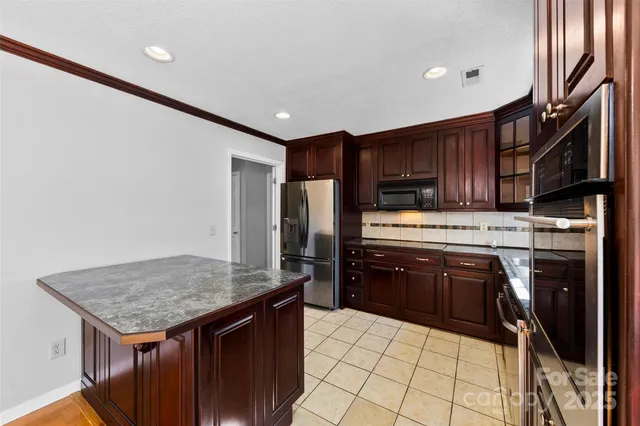 a kitchen with a stove a refrigerator and a sink