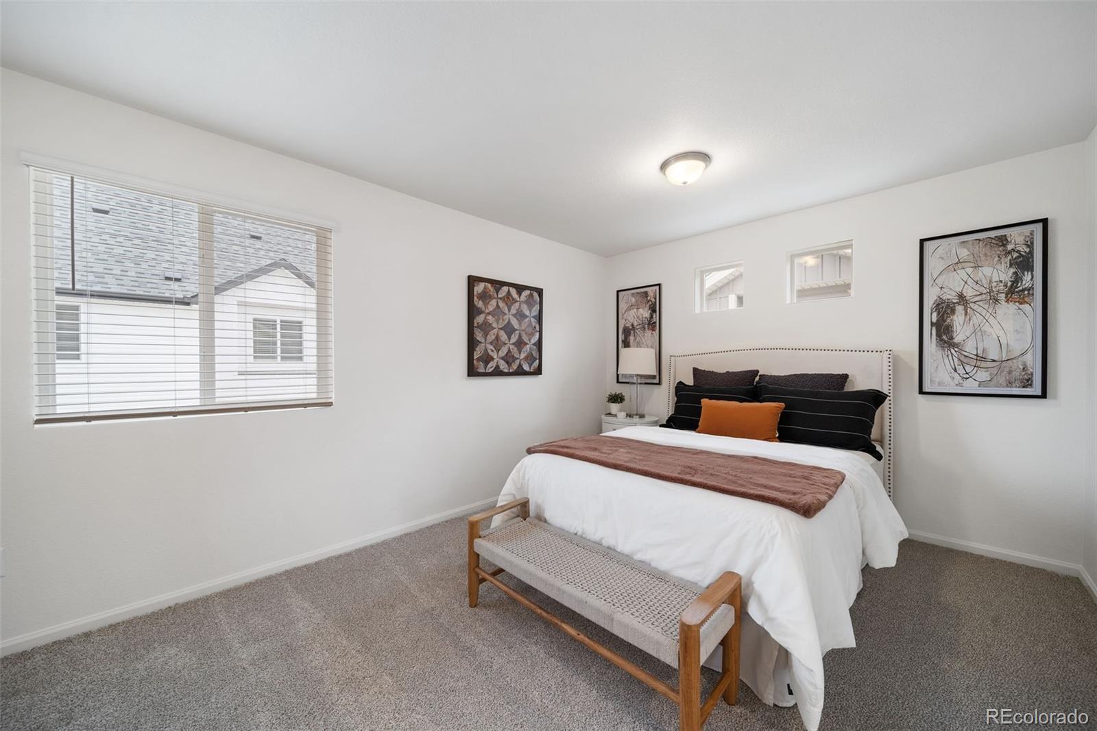 3372 Baltin Road Johnstown, CO 80534 - Photo 14 of 24 a spacious bedroom with a bed and glass windows