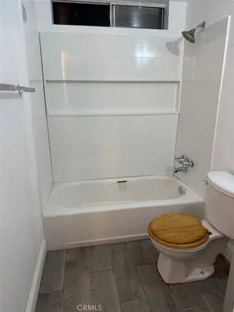 a bathroom with a toilet and a bath tub