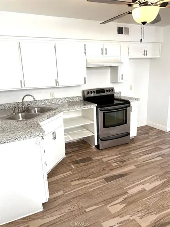a kitchen with granite countertop a stove and a sink
