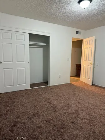 a view of an empty room and closet area