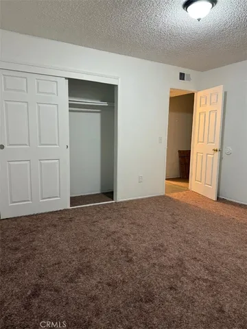 a view of an empty room and closet area