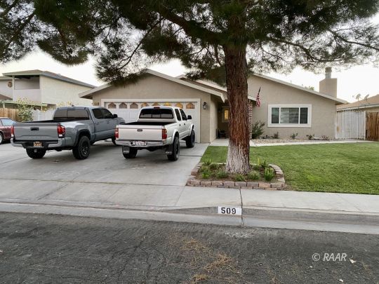 509 South Appaloosa Street Ridgecrest, CA 93555 - Photo 1 of 26 a car parked in front of a white house