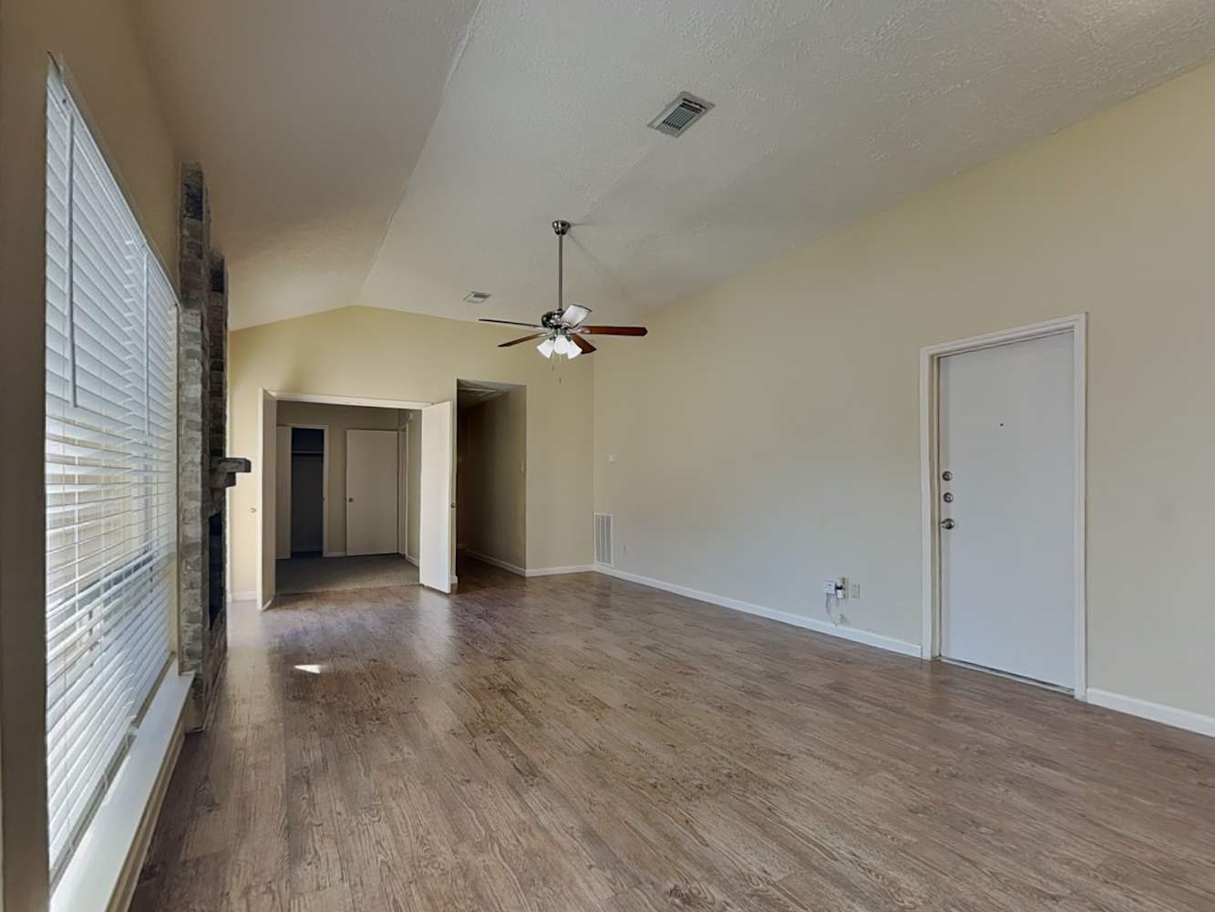 9203 Rippling Fields Drive Houston, TX 77064 - Photo 3 of 16 wooden floor in an empty room with a window