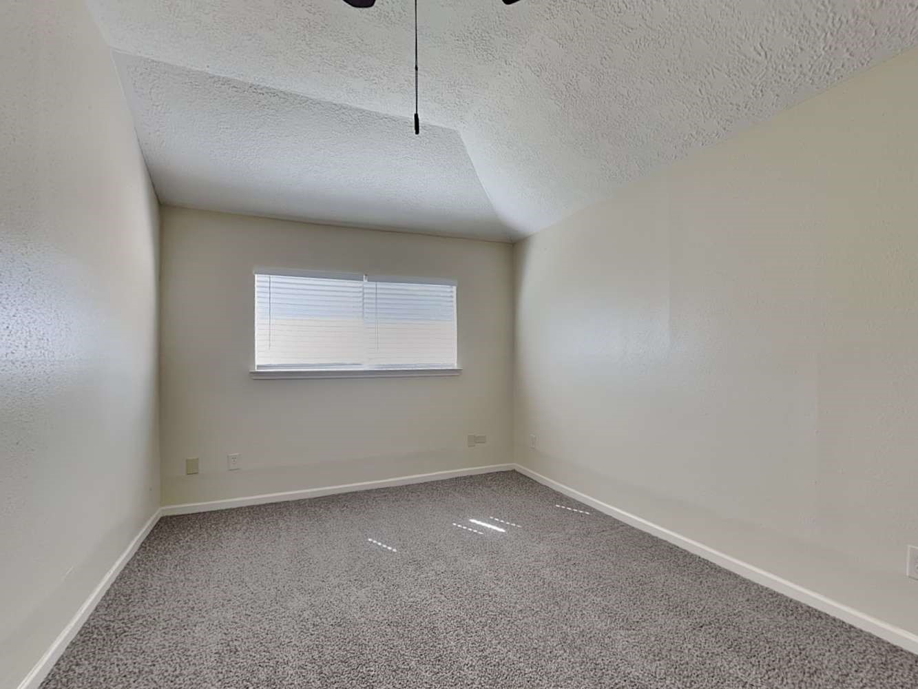 9203 Rippling Fields Drive Houston, TX 77064 - Photo 7 of 16 an empty room with a empty space and windows
