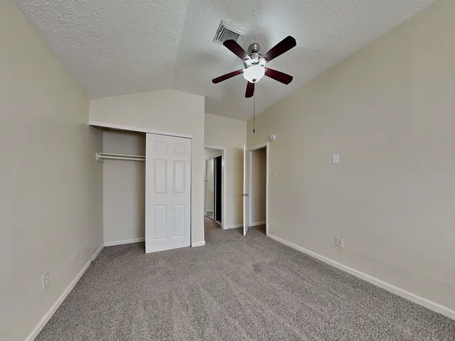 a view of a big room with a chandelier fan