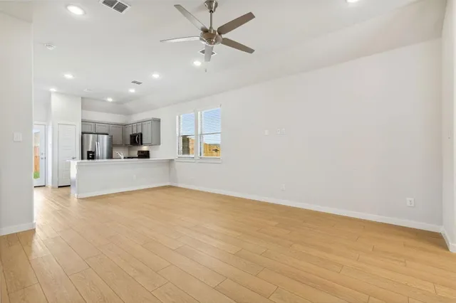 a view of a kitchen with a sink and wooden floor
