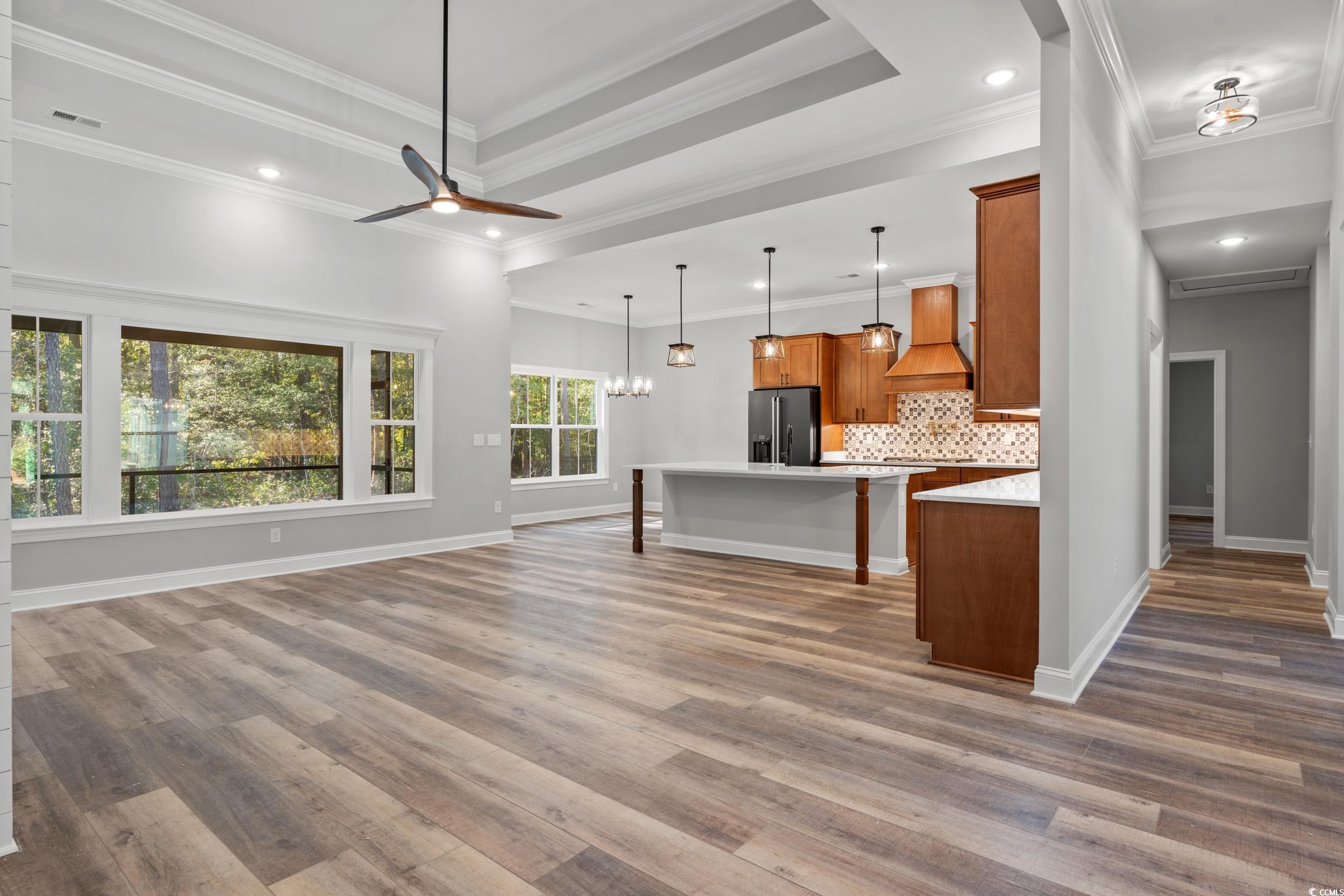 8016 Old Reaves Ferry Road Conway, SC 29526 - Photo 31 of 33 Kitchen with brown cabinets, open floor plan, tasteful backsplash, high end refrigerator, and dark wood-style floors