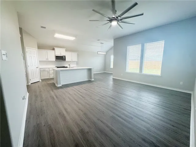 a view of kitchen with sink microwave and stove