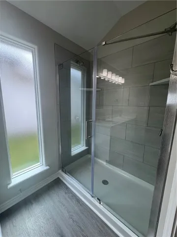 a bathroom with a glass shower door