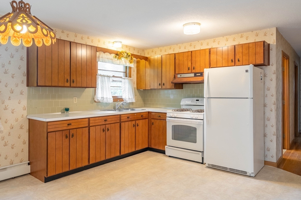 58 Wedgewood Road Worcester, MA 01602 - Photo 7 of 28 a kitchen with stainless steel appliances granite countertop a refrigerator sink and cabinets