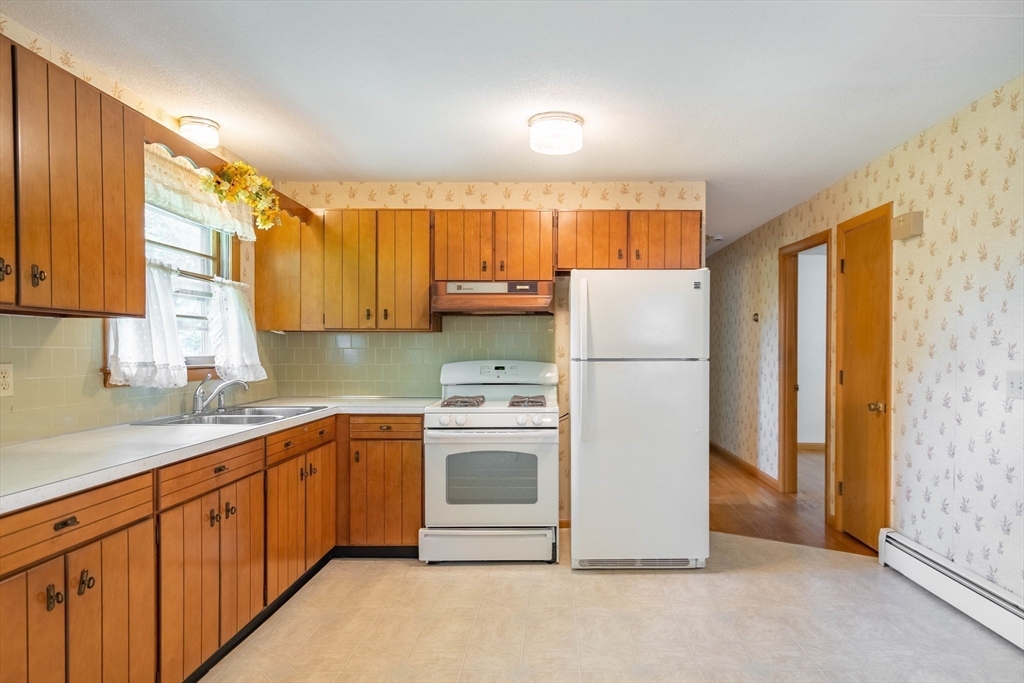 58 Wedgewood Road Worcester, MA 01602 - Photo 10 of 28 a kitchen with a sink a refrigerator and cabinets