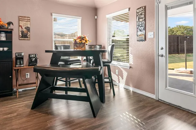 a dining room with furniture and wooden floor
