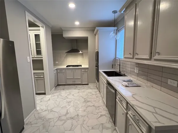 a kitchen with a sink stove and cabinets