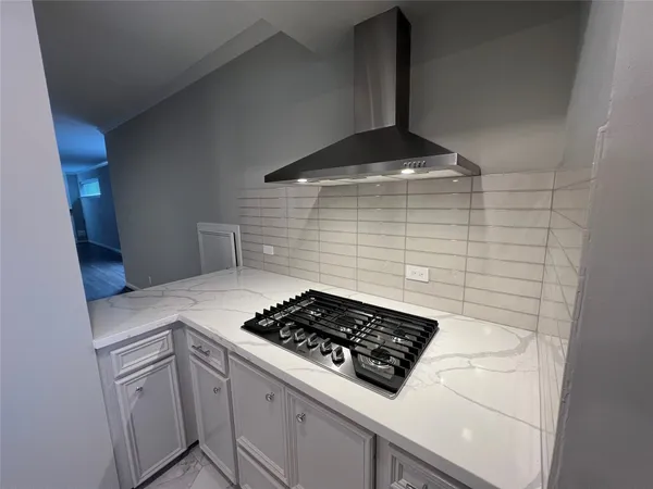 a kitchen with a sink a stove and a refrigerator