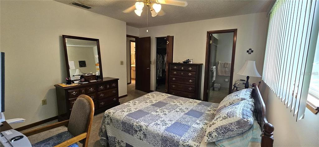 10881 Southwest 79th Terrace Ocala, FL 34476 - Photo 12 of 38 a bedroom with a bed and wooden floor