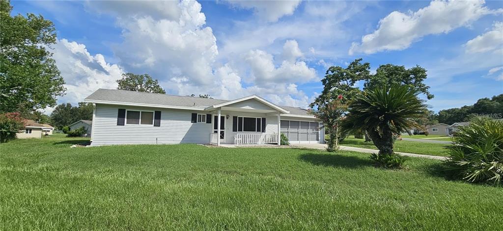 10881 Southwest 79th Terrace Ocala, FL 34476 - Photo 2 of 38 a front view of a house with a yard and trees