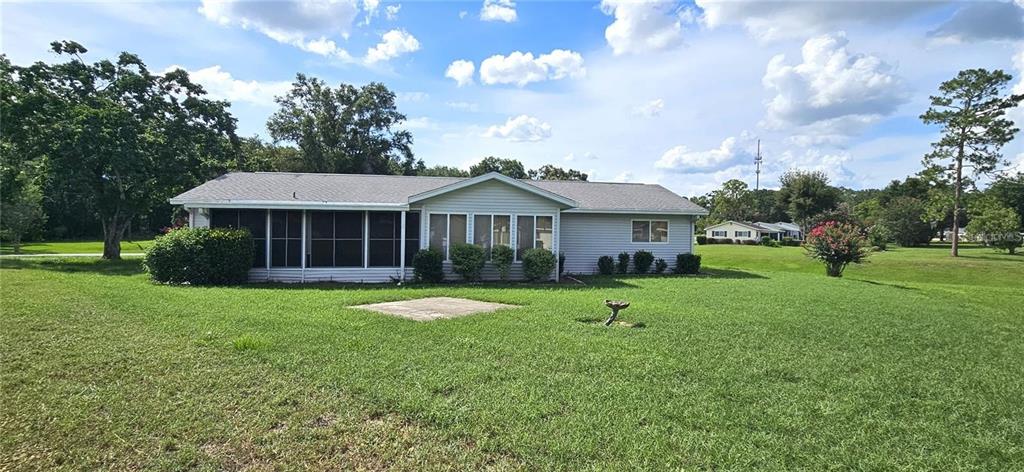 10881 Southwest 79th Terrace Ocala, FL 34476 - Photo 5 of 38 a front view of a house with a yard and trees