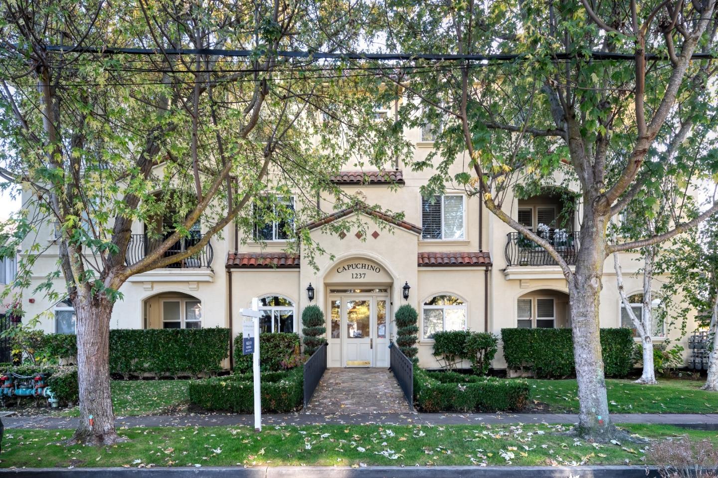 1237 Capuchino Avenue, Unit 7 Burlingame, CA 94010 - Photo 1 of 40 a front view of a house with garden