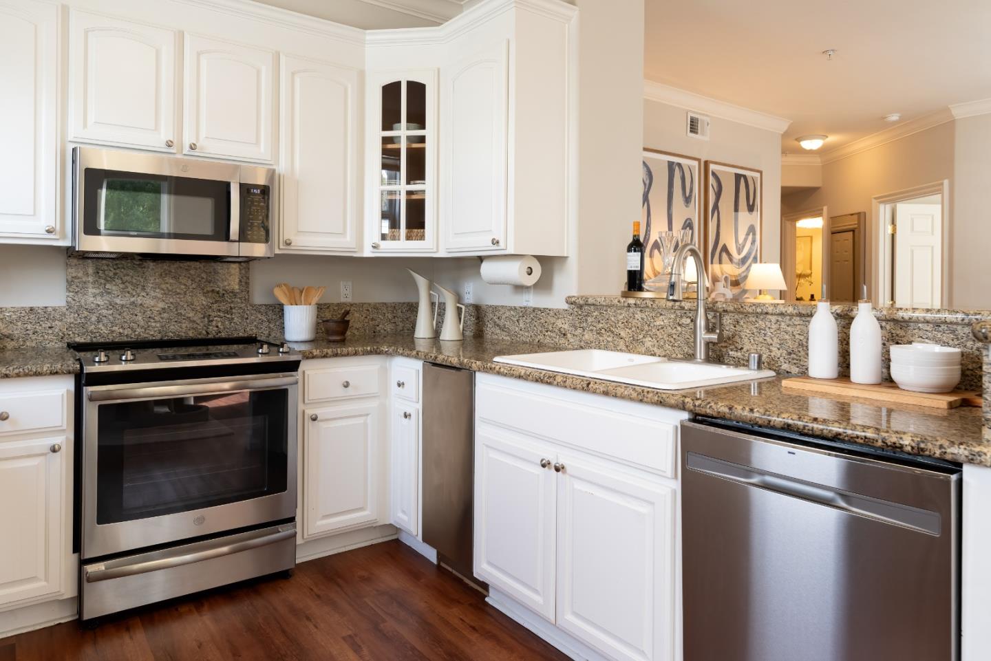 1237 Capuchino Avenue, Unit 7 Burlingame, CA 94010 - Photo 13 of 40 a kitchen with granite countertop white cabinets stainless steel appliances and sink
