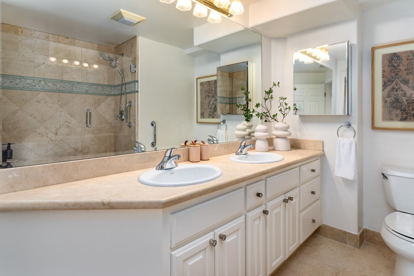 1237 Capuchino Avenue, Unit 7 Burlingame, CA 94010 - Photo 22 of 40 a bathroom with a double vanity sink and a mirror