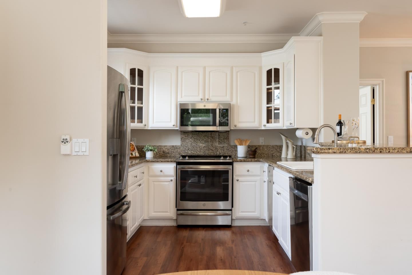 1237 Capuchino Avenue, Unit 7 Burlingame, CA 94010 - Photo 10 of 40 a kitchen with granite countertop a stove and a sink
