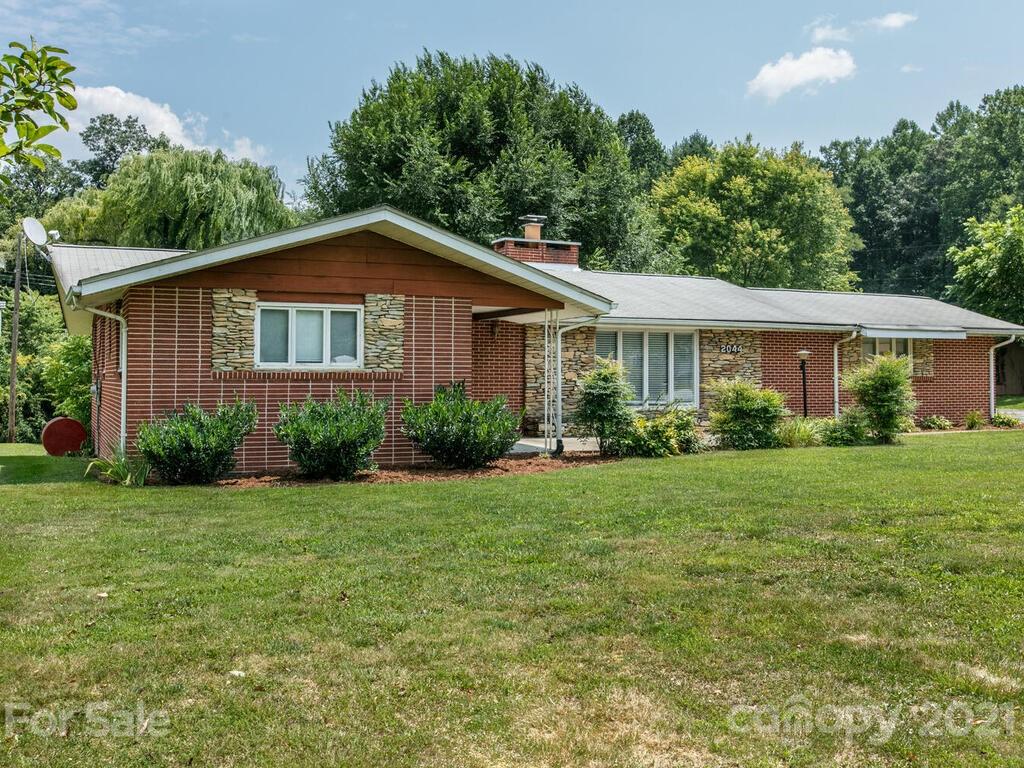 2044 Ridge Road Hendersonville, NC 28792 - Photo 1 of 37 a front view of a house with a yard and trees